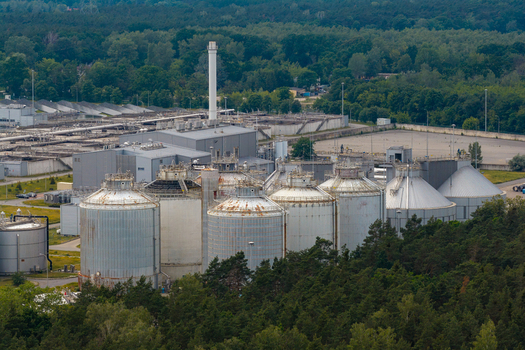 Aerial view of the wastewater treatment plant featuring large industrial tanks processing facilities and surrounding forest in Warsaw Masovian Voivodeship Poland. Aerial view of the wastewater treatment plant featuring large industrial tanks processing facilities and surrounding forest in Warsaw Masovian Voivodeship Poland.