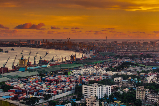 Chittagong Chittagong Division Bangladesh 01 September 2021 Aerial view of Chattogram Port with shipping containers industrial cranes and cargo ships along the river at sunset.