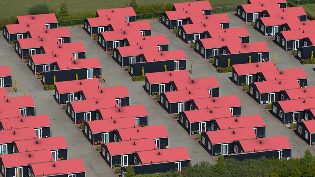 Drone view of AZC Luttelgeest in the Netherlands showing a reception centre for asylum seekers temporary housing community facilities and social infrastructure. Drone view of AZC Luttelgeest in the Netherlands showing a reception centre for asylum seekers temporary housing community facilities and social infrastructure.