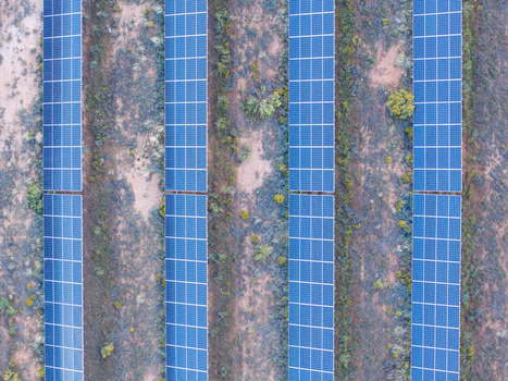 Aerial view of rows of solar panels installed in a desert landscape with sparse vegetation in Colorado United States. Aerial view of rows of solar panels installed in a desert landscape with sparse vegetation in Colorado United States.