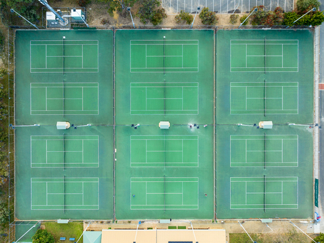 Aerial view of Sorrento Tennis Club featuring multiple green tennis courts with white lines and surrounding fencing in Duncraig Western Australia Australia. Aerial view of Sorrento Tennis Club featuring multiple green tennis courts with white lines and surrounding fencing in Duncraig Western Australia Australia.