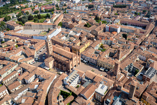 Aerial view of the Alba Cathedral and the historic old town with medieval towers and red tiled rooftops in Alba Piedmont Italy.