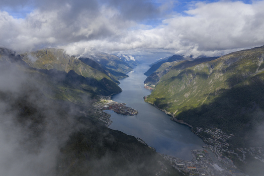 Aerial view of the town of Odda at the end of Sorfjorden with steep mountains and low clouds Odda Vestland Norway. Aerial view of the town of Odda at the end of Sorfjorden with steep mountains and low clouds Odda Vestland Norway.