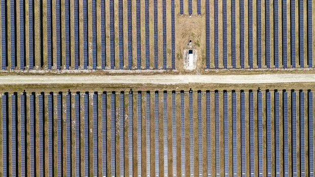 Aerial view of rows of dark solar panels contrasting against the golden fields a stark display of modern energy landscape Elkton Florida United States. Aerial view of rows of dark solar panels contrasting against the golden fields a stark display of modern energy landscape Elkton Florida United States.