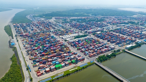 Aerial view of Jawaharlal Nehru Port Authority container terminal with rows of colorful shipping containers port infrastructure and coastal surroundings in Juna Sheva Maharashtra India. Aerial view of Jawaharlal Nehru Port Authority container terminal with rows of colorful shipping containers port infrastructure and coastal surroundings in Juna Sheva Maharashtra India.