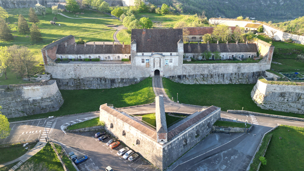 Aerial view of the historic Besancon Citadel with its massive stone fortifications and surrounding green landscape in Besancon Bourgogne Franche Comte France. Aerial view of the historic Besancon Citadel with its massive stone fortifications and surrounding green landscape in Besancon Bourgogne Franche Comte France.