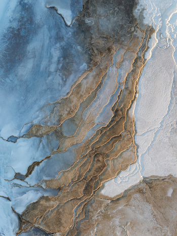 Aerial view of the geothermal landscape of Reykjanes featuring intricate mineral rich terraced formations and volcanic terrain in Grindavikurbaer Iceland. Aerial view of the geothermal landscape of Reykjanes featuring intricate mineral rich terraced formations and volcanic terrain in Grindavikurbaer Iceland.
