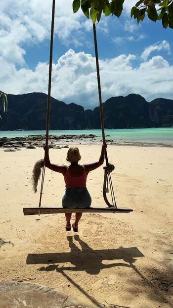 View of a person on a swing at Ao Nang beach Thailand.