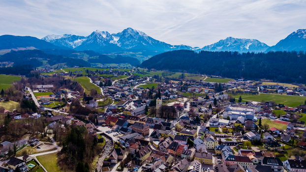 Aerial view of the valley where snow capped mountains meet the quaint town a tapestry of rooftops and verdant fields Windischgarsten Upper Austria Austria. Aerial view of the valley where snow capped mountains meet the quaint town a tapestry of rooftops and verdant fields Windischgarsten Upper Austria Austria.