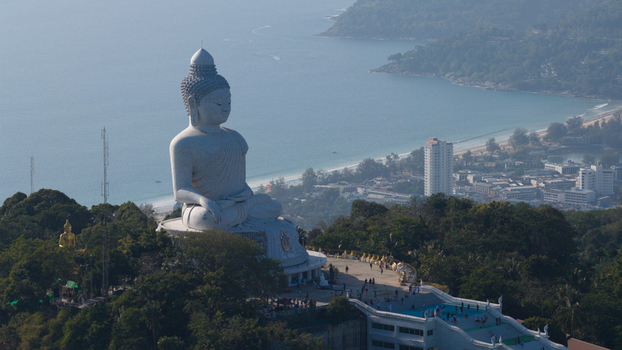 Aerial view of the Big Buddha Phuket statue on Nakkerd Hill overlooking the Andaman Sea and coastline with people on the observation deck Karon Phuket Thailand. Aerial view of the Big Buddha Phuket statue on Nakkerd Hill overlooking the Andaman Sea and coastline with people on the observation deck Karon Phuket Thailand.