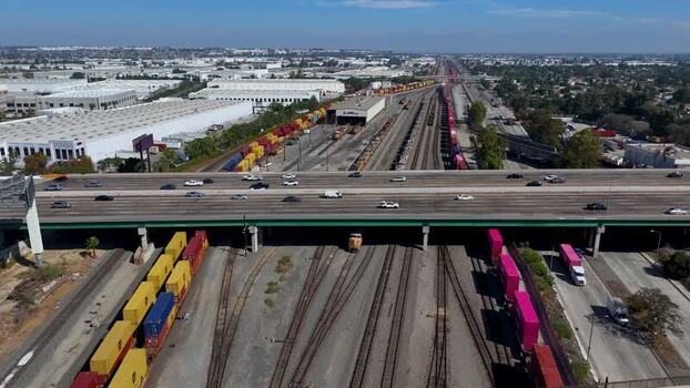 Aerial view of highway overpass and rail yard in United States.
