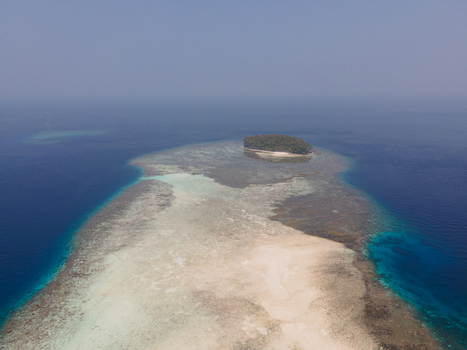 Aerial view of Pasir Timbul Mansuar sandbar with turquoise coral reefs and deep blue ocean waters Raja Ampat Papua Barat Indonesia. Aerial view of Pasir Timbul Mansuar sandbar with turquoise coral reefs and deep blue ocean waters Raja Ampat Papua Barat Indonesia.