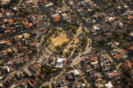 Aerial view of a circular plaza surrounded by dense residential buildings and rooftops in the urban landscape of Rio de Janeiro Rio de Janeiro Brazil. Aerial view of a circular plaza surrounded by dense residential buildings and rooftops in the urban landscape of Rio de Janeiro Rio de Janeiro Brazil.