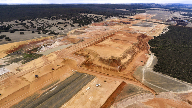 Aerial view of an industrial mining site with exposed sand earth and salt deposits featuring heavy machinery and textured terrain in Kalbarri Western Australia Australia. Aerial view of an industrial mining site with exposed sand earth and salt deposits featuring heavy machinery and textured terrain in Kalbarri Western Australia Australia.