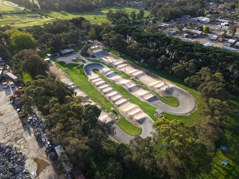 Melbourne VIC Australia 22 September 2026 Aerial view of Kilsyth BMX track with dirt jumps and banked turns surrounded by grass and eucalyptus trees in a suburban area. Melbourne VIC Australia 22 September 2026 Aerial view of Kilsyth BMX track with dirt jumps and banked turns surrounded by grass and eucalyptus trees in a suburban area.