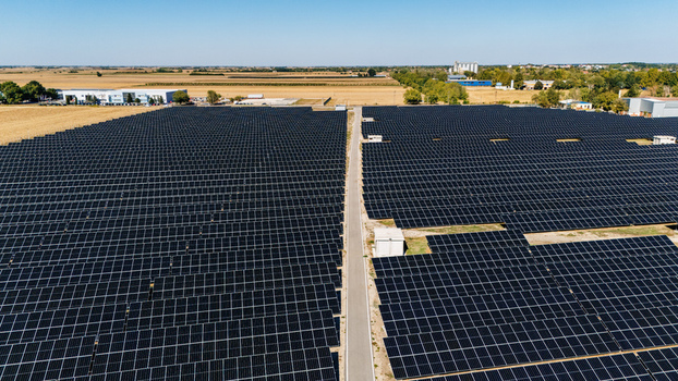 Aerial view of a large solar farm with rows of photovoltaic panels under a clear blue sky in Temerin Vojvodina Serbia. Aerial view of a large solar farm with rows of photovoltaic panels under a clear blue sky in Temerin Vojvodina Serbia.