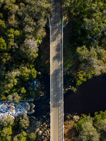 Aerial view of Upper Kalgan Bridge spanning the river surrounded by dense native forest and rocky terrain in Kalgan Western Australia Australia. Aerial view of Upper Kalgan Bridge spanning the river surrounded by dense native forest and rocky terrain in Kalgan Western Australia Australia.