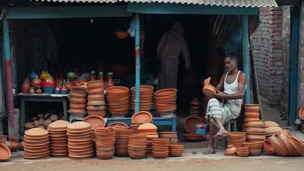 View of a potter working in a traditional clay shop Bangladesh. View of a potter working in a traditional clay shop Bangladesh.
