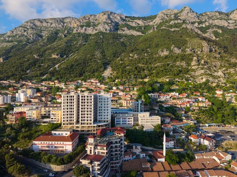 Aerial view of the hillside town of Kruje featuring a mix of modern and traditional architecture against a backdrop of rugged mountains in Kruje Durres County Albania.