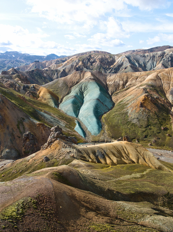 Aerial view of Landmannalaugar featuring colorful rhyolite mountains volcanic landscapes and rugged terrain under a bright sky in Hella Rangarthing ytra Iceland. Aerial view of Landmannalaugar featuring colorful rhyolite mountains volcanic landscapes and rugged terrain under a bright sky in Hella Rangarthing ytra Iceland.