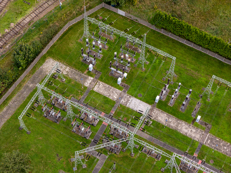 Aerial view of an electrical substation with metal towers and power equipment situated on a grassy field in Gdansk Poland. Aerial view of an electrical substation with metal towers and power equipment situated on a grassy field in Gdansk Poland.