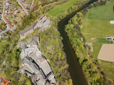 Aerial view of Orava Castle perched on a high rock cliff overlooking the Orava river and surrounding green forests in Oravsky Podzamok Zilina Region Slovakia. Aerial view of Orava Castle perched on a high rock cliff overlooking the Orava river and surrounding green forests in Oravsky Podzamok Zilina Region Slovakia.