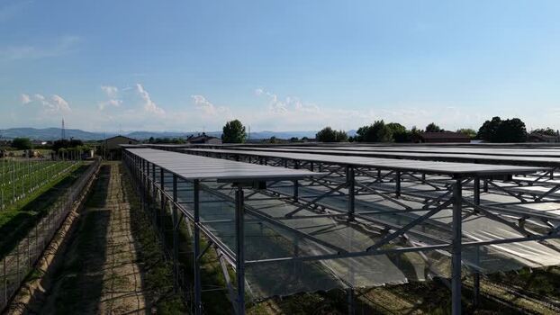 Aerial view of solar panels over a vineyard in Faenza Italy.