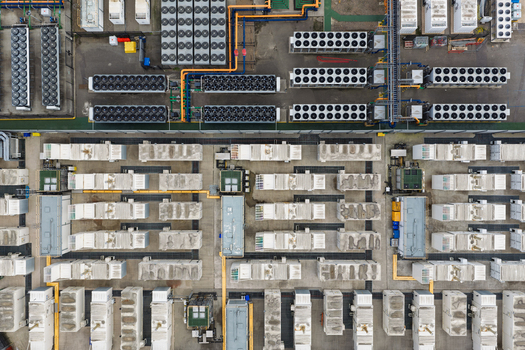Aerial view of a data center with rows of cooling units and server containers in the United Kingdom.