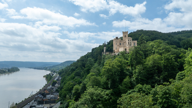 Aerial view of Stolzenfels Castle perched on a lush green hill overlooking the Rhine river and the surrounding valley in Koblenz Rheinland Pfalz Germany. Aerial view of Stolzenfels Castle perched on a lush green hill overlooking the Rhine river and the surrounding valley in Koblenz Rheinland Pfalz Germany.