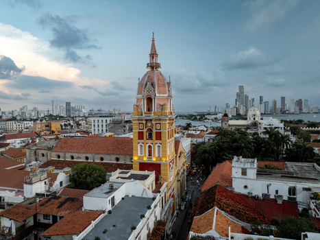Aerial view of the historic San Pedro Claver Church with its iconic bell tower rising above the terracotta rooftops of the old town in Cartagena Bolivar Colombia. Aerial view of the historic San Pedro Claver Church with its iconic bell tower rising above the terracotta rooftops of the old town in Cartagena Bolivar Colombia.