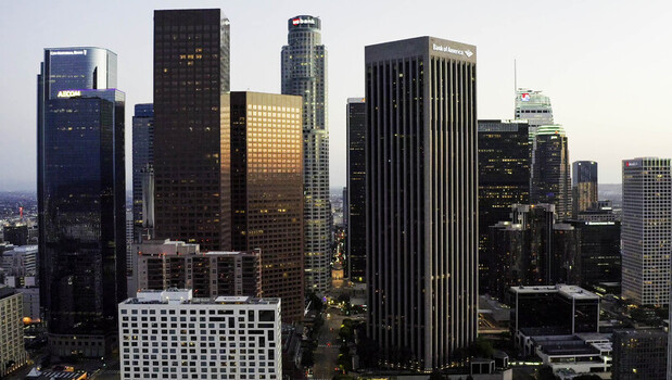 Los Angeles CA United States 28 September 2026 Aerial view of the downtown Los Angeles skyline at sunset featuring skyscrapers reflective glass facades and urban streets in golden light.