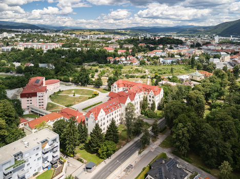 Aerial view of the Faculty of Economics Matej Bel University featuring red roofed buildings surrounded by lush trees in Banska Bystrica Banskobystricky kraj Slovakia. Aerial view of the Faculty of Economics Matej Bel University featuring red roofed buildings surrounded by lush trees in Banska Bystrica Banskobystricky kraj Slovakia.