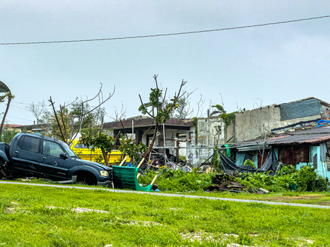 San Jose Tinian Northern Mariana Islands 06 July 2026 View of storm damage from Super Typhoon Bavi with a damaged vehicle debris and ruined structures under cloudy skies. San Jose Tinian Northern Mariana Islands 06 July 2026 View of storm damage from Super Typhoon Bavi with a damaged vehicle debris and ruined structures under cloudy skies.