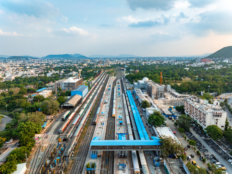 Aerial view of Udaipur railway station with multiple tracks trains blue roof platforms and surrounding urban landscape in Udaipur Rajasthan India. Aerial view of Udaipur railway station with multiple tracks trains blue roof platforms and surrounding urban landscape in Udaipur Rajasthan India.
