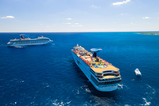 The Berry Islands The Bahamas 02 May 2020 Aerial view of two Carnival cruise ships sailing in the deep blue waters of the Caribbean Sea under a clear sky.