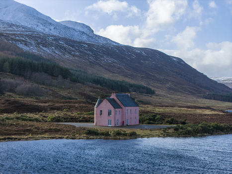 Aerial view of The Pink House on the shore of Loch Glass surrounded by snow capped hills and pine forests Dingwall Scotland United Kingdom. Aerial view of The Pink House on the shore of Loch Glass surrounded by snow capped hills and pine forests Dingwall Scotland United Kingdom.