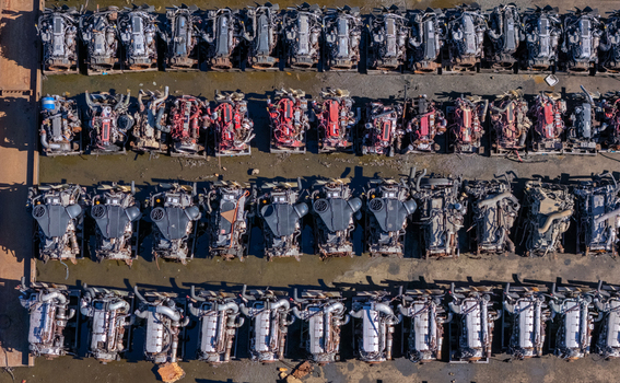 Aerial view of rows of scrapped heavy duty truck engines arranged in a salvage yard showing mechanical components and metal parts in Kalamazoo Michigan United States.