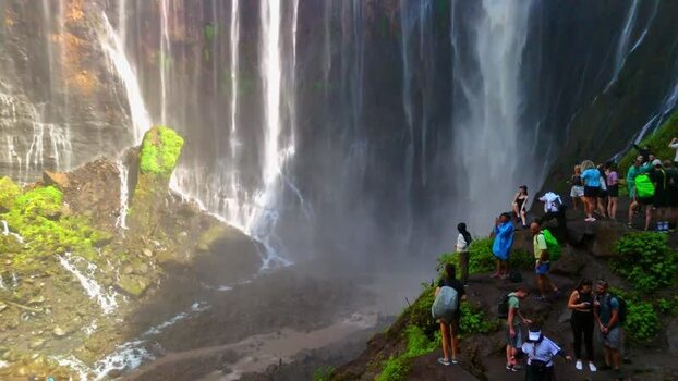 Aerial view of Tumpak Sewu Waterfall with tourists Indonesia.