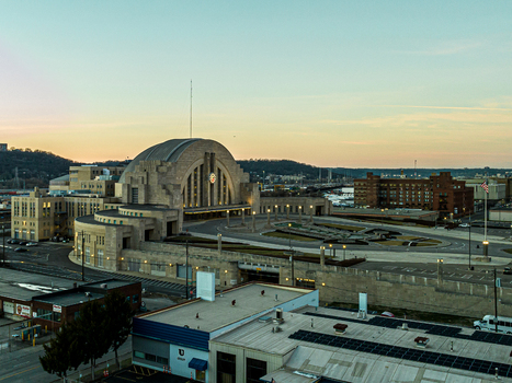 Aerial view of the iconic Cincinnati Union Terminal stands majestically against the soft hues of the setting sun its art deco facade glowing warmly Cincinnati Ohio United States. Aerial view of the iconic Cincinnati Union Terminal stands majestically against the soft hues of the setting sun its art deco facade glowing warmly Cincinnati Ohio United States.