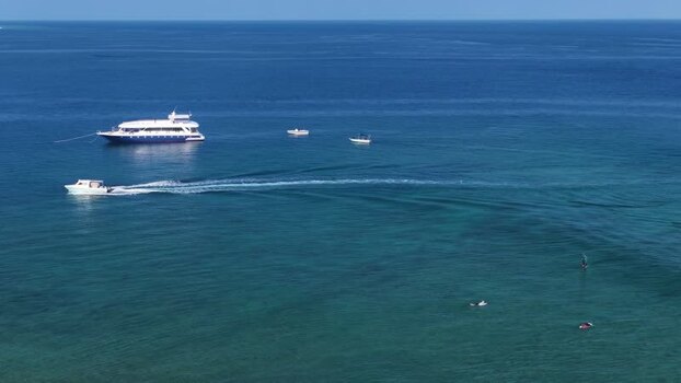 Aerial view of boats in turquoise ocean waters Maldives. Aerial view of boats in turquoise ocean waters Maldives.
