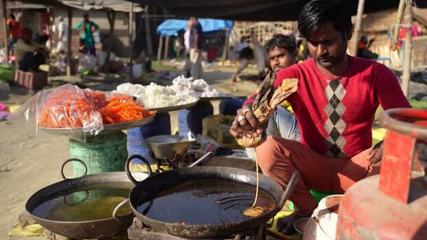 View of a man preparing traditional sweets at a market Nepal. View of a man preparing traditional sweets at a market Nepal.