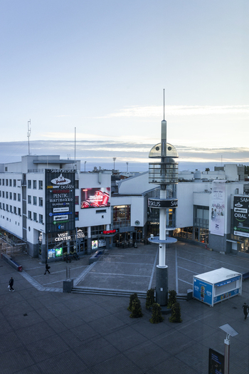Rovaniemi Finland 19 September 2026 Aerial view of the Sampokeskus shopping center with its distinctive tower surrounding urban buildings and paved plaza under a clear sky.
