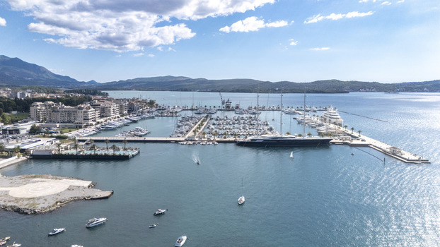 Aerial view of Porto Montenegro marina with luxury yachts modern waterfront buildings and calm blue waters in Tivat Tivat Municipality Montenegro. Aerial view of Porto Montenegro marina with luxury yachts modern waterfront buildings and calm blue waters in Tivat Tivat Municipality Montenegro.