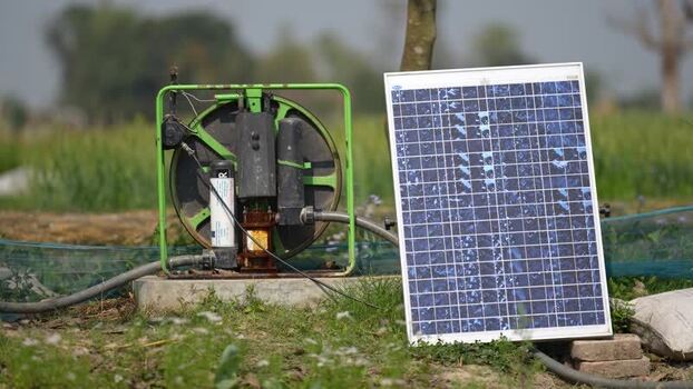 View of a solar powered water pump in a rural field Nepal.