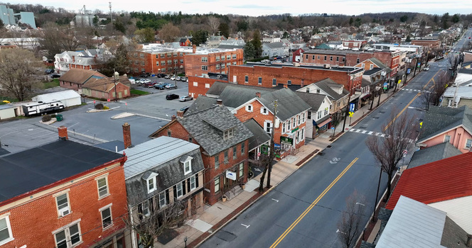 Aerial view of downtown Elizabethtown featuring historic brick buildings a quiet street and residential rooftops in Elizabethtown Pennsylvania United States.
