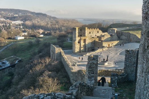 View of Devin Castle ruins with stone walls and people walking in the courtyard under a clear sky in Bratislava IV Bratislava Region Slovakia. View of Devin Castle ruins with stone walls and people walking in the courtyard under a clear sky in Bratislava IV Bratislava Region Slovakia.