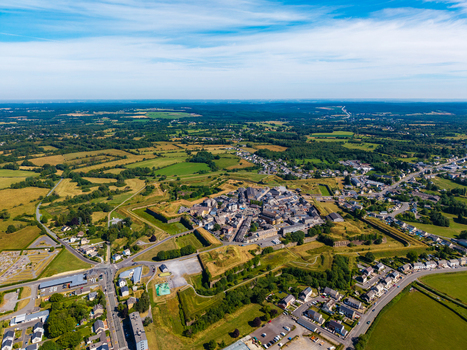 Aerial view of the star shaped historic fortifications of Fort Neuf surrounding the town of Rocroi with green fields and roads in the countryside of Rocroi Grand Est France. Aerial view of the star shaped historic fortifications of Fort Neuf surrounding the town of Rocroi with green fields and roads in the countryside of Rocroi Grand Est France.