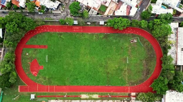 Aerial view of a red running track and green field in Mexico. Aerial view of a red running track and green field in Mexico.
