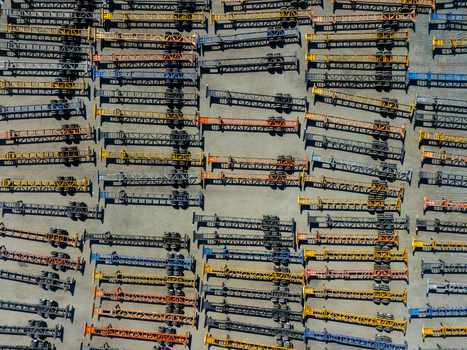 Aerial view of numerous semi trailer chassis parked in neat rows at a logistics facility in Carson California United States.