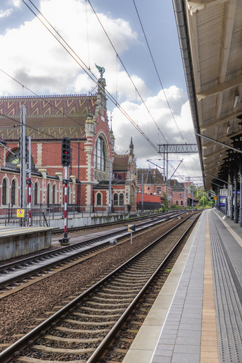 Gdansk Poland 06 September 2026 View of the historic Gdansk Glowny railway station with its red brick facade clock tower and tracks along the platform under a cloudy sky. Gdansk Poland 06 September 2026 View of the historic Gdansk Glowny railway station with its red brick facade clock tower and tracks along the platform under a cloudy sky.